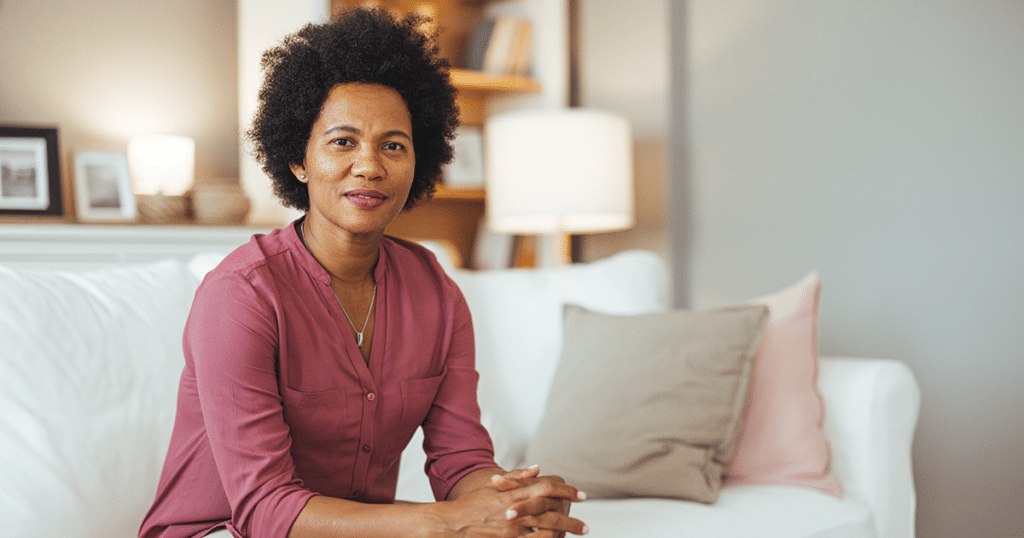 Woman sitting on couch.